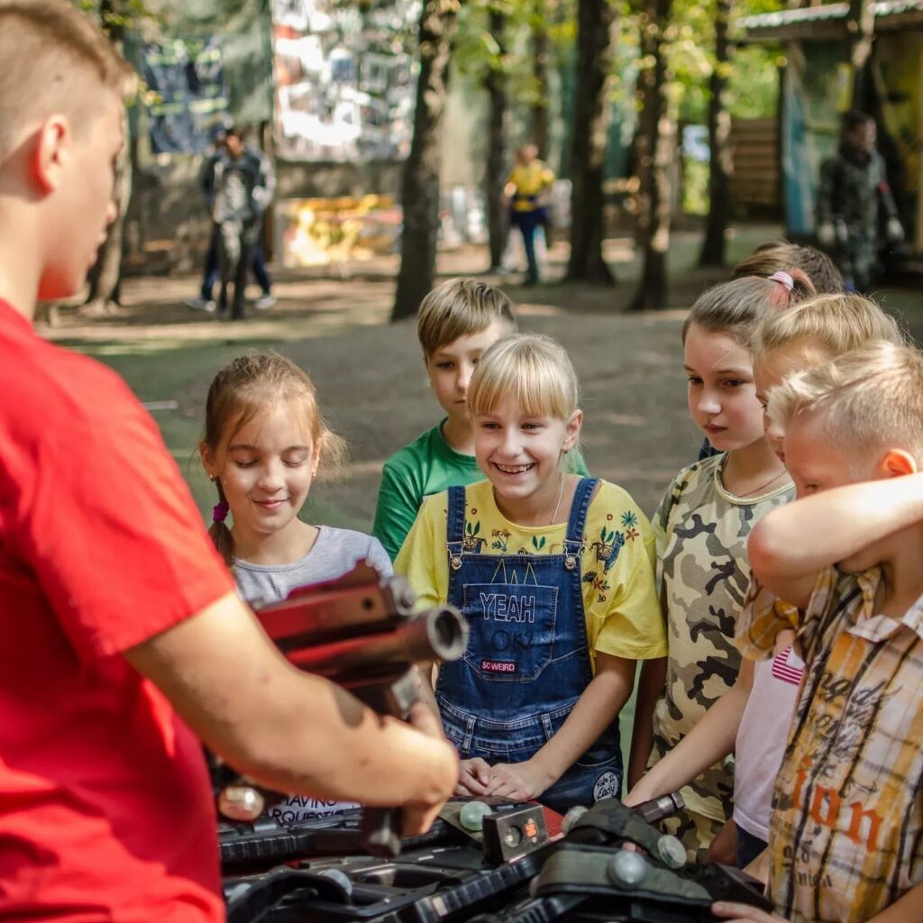 Kids looking at laser tag equipment