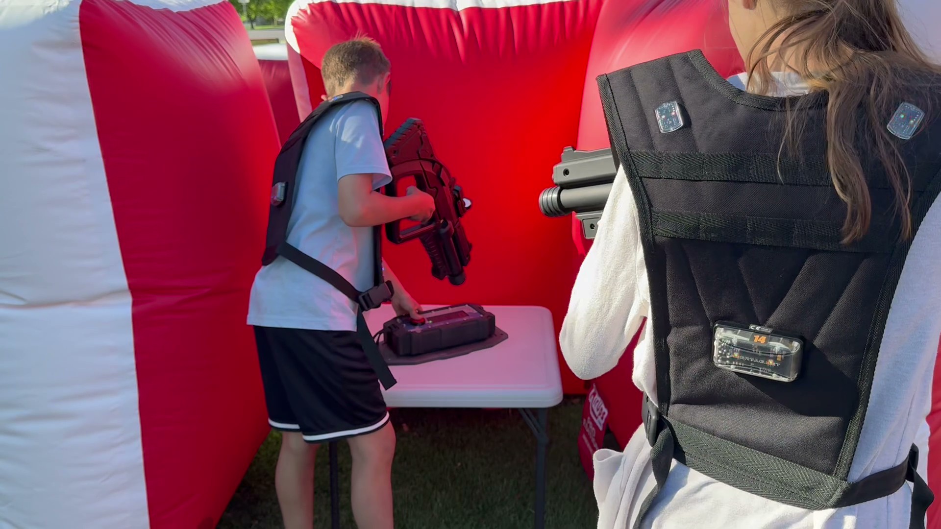 Player arming or disarming a laser tag bomb inside the laser tag arena